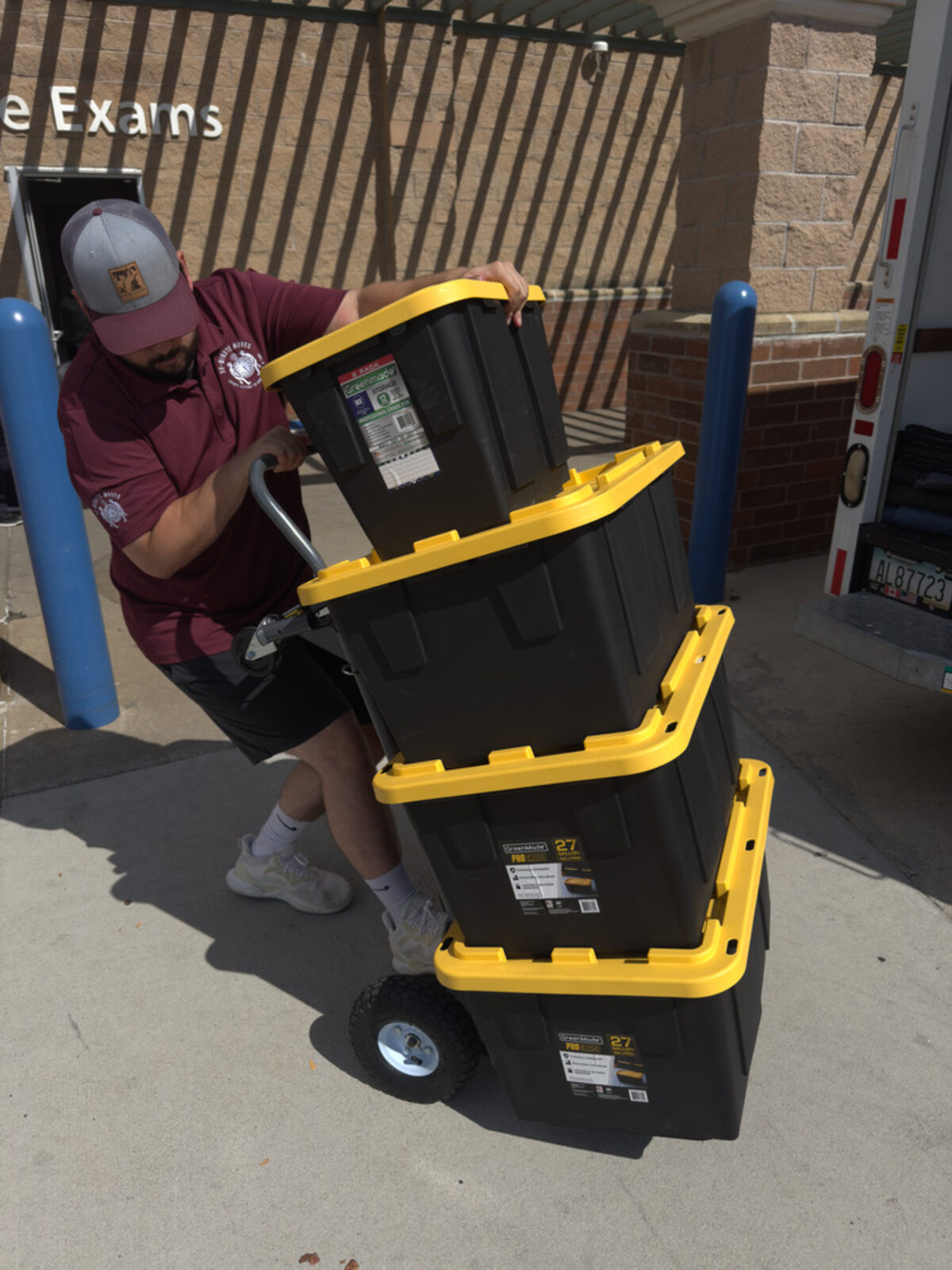 30-Minute Moves crew member moving stacked bins with a hand truck